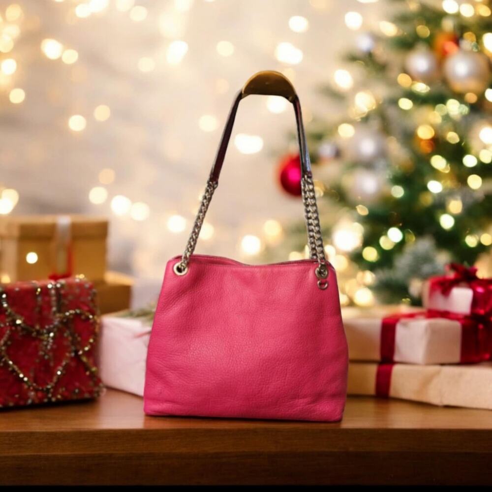 Michael Kors fushia pebbled leather shoulder bag.